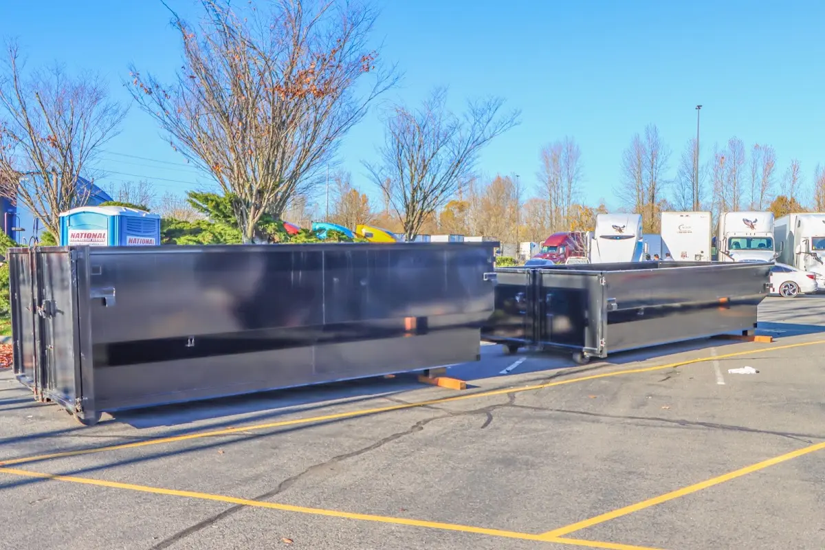 Professional dumpster rental service with roll-off container on residential driveway in North Strabane